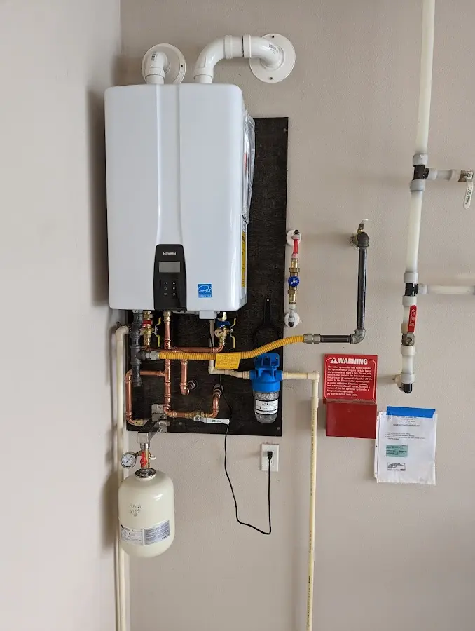 Professional plumber installing copper piping in a Cloverleaf home